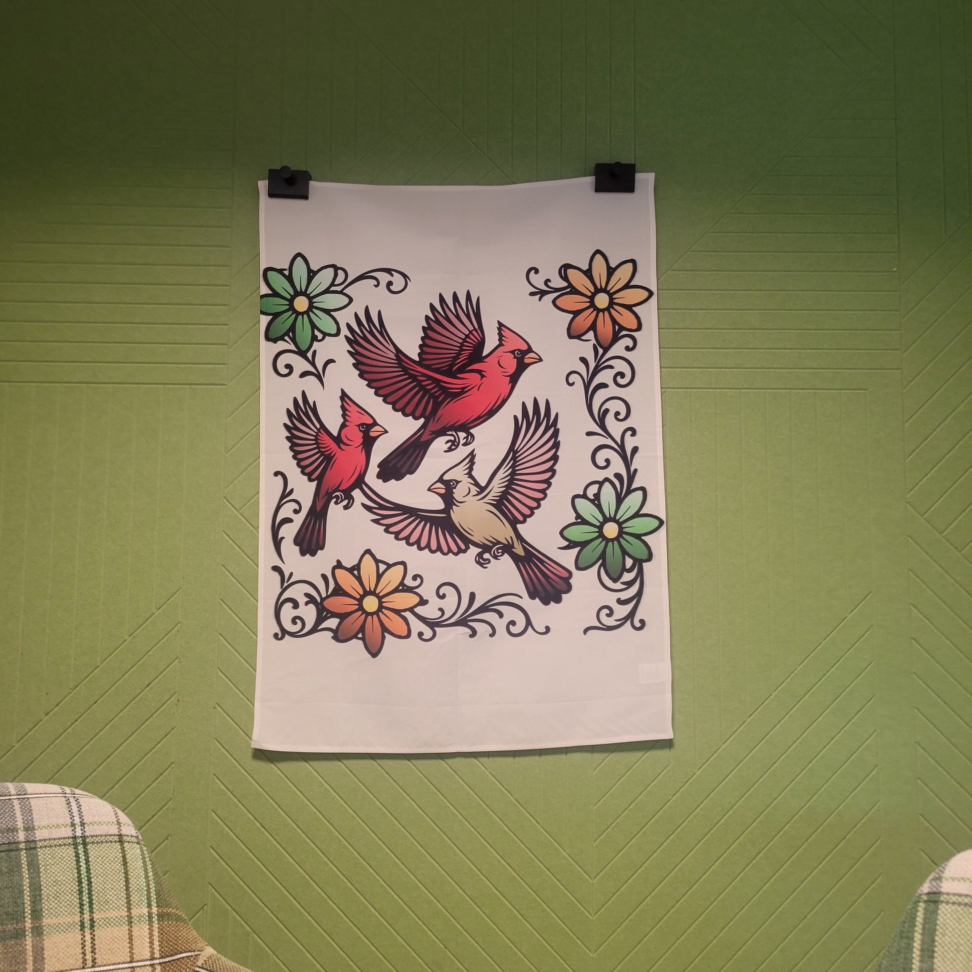 Three flying cardinals in red and tan with bold black outlines, surrounded by decorative floral swirls in green and orange on a beige background. Wall art poster.