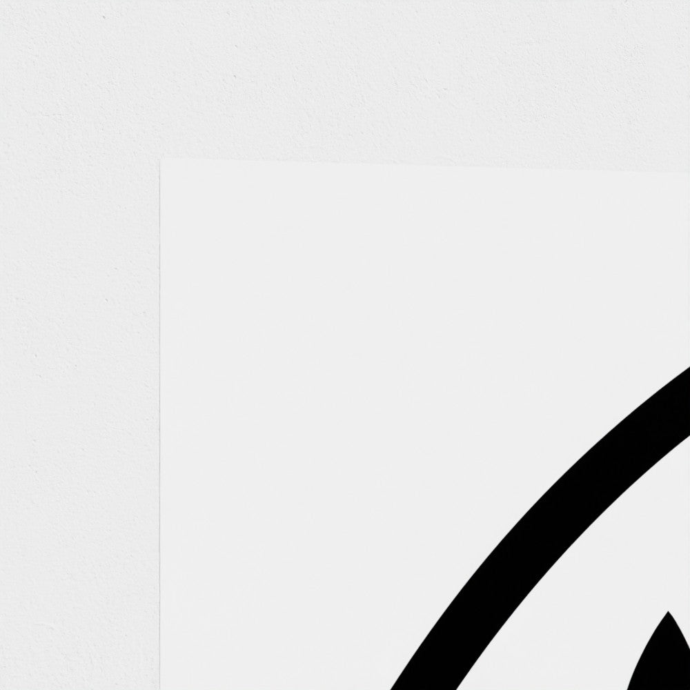 Close-up corner detail of a white print showing bold black curved lines of a partially visible symbol, wall art.