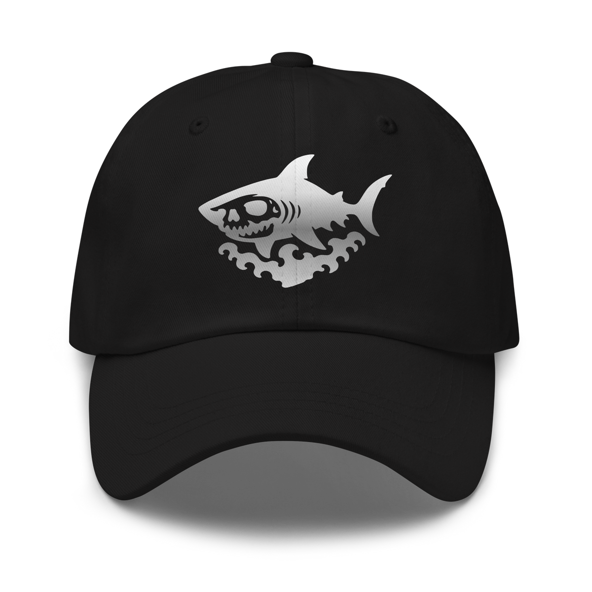 Black dad hat with a silver embroidered skull-faced shark over stylized ocean waves, centered on the front panel. Dad hat.