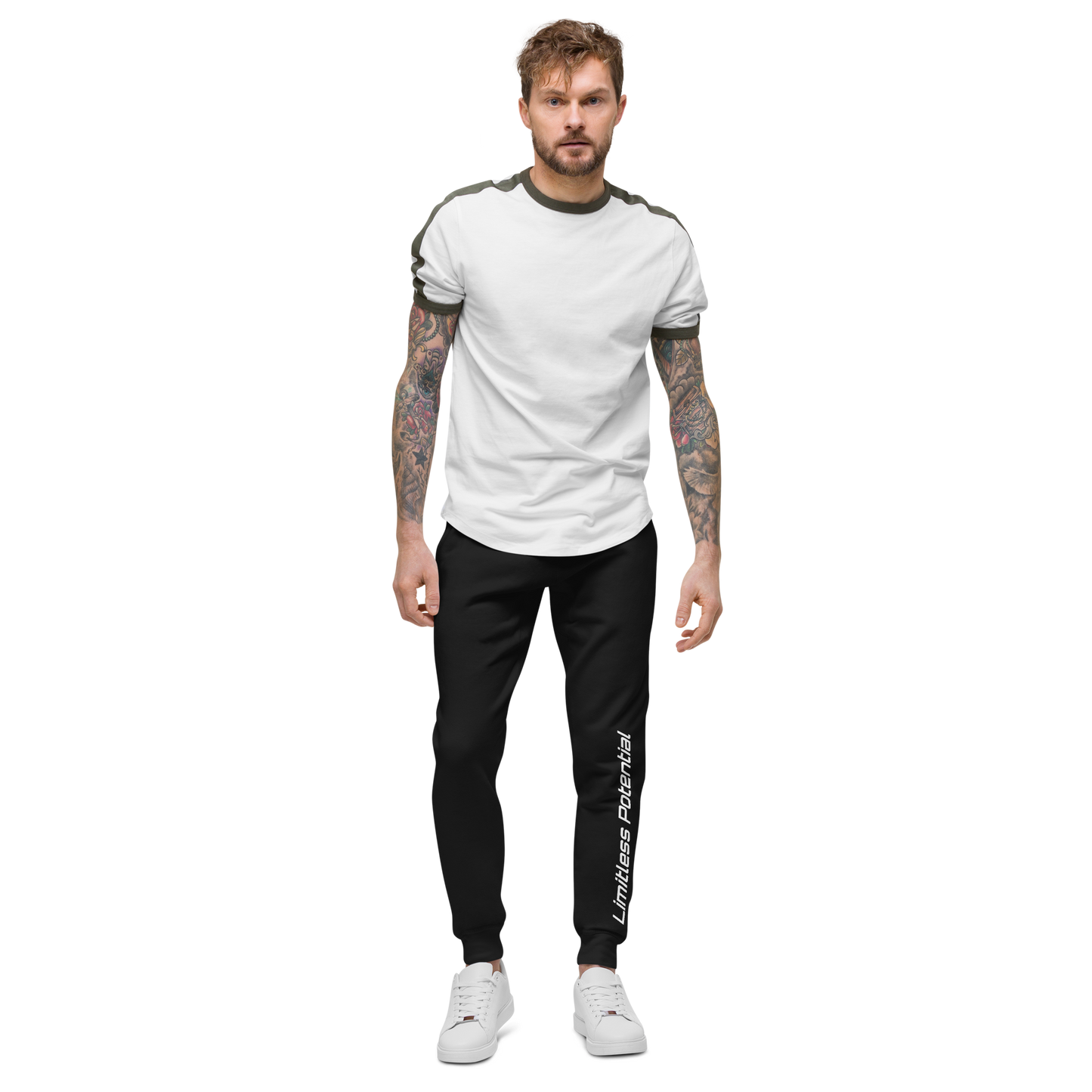 Male model wearing black jogger pants with "Limitless Potential" printed along the left leg in white, paired with a white and olive shirt — apparel.