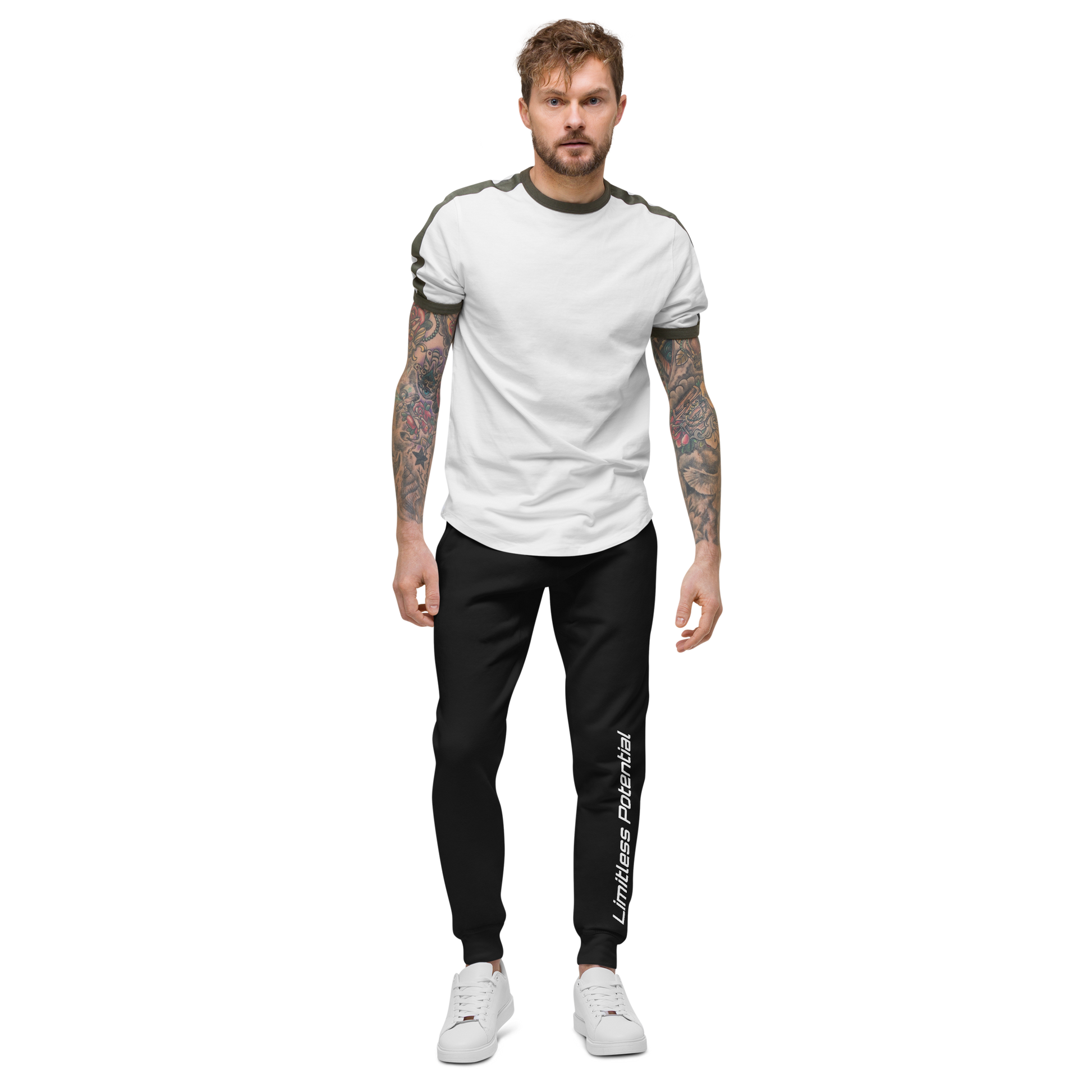 Male model wearing black jogger pants with "Limitless Potential" printed along the left leg in white, paired with a white and olive shirt — apparel.