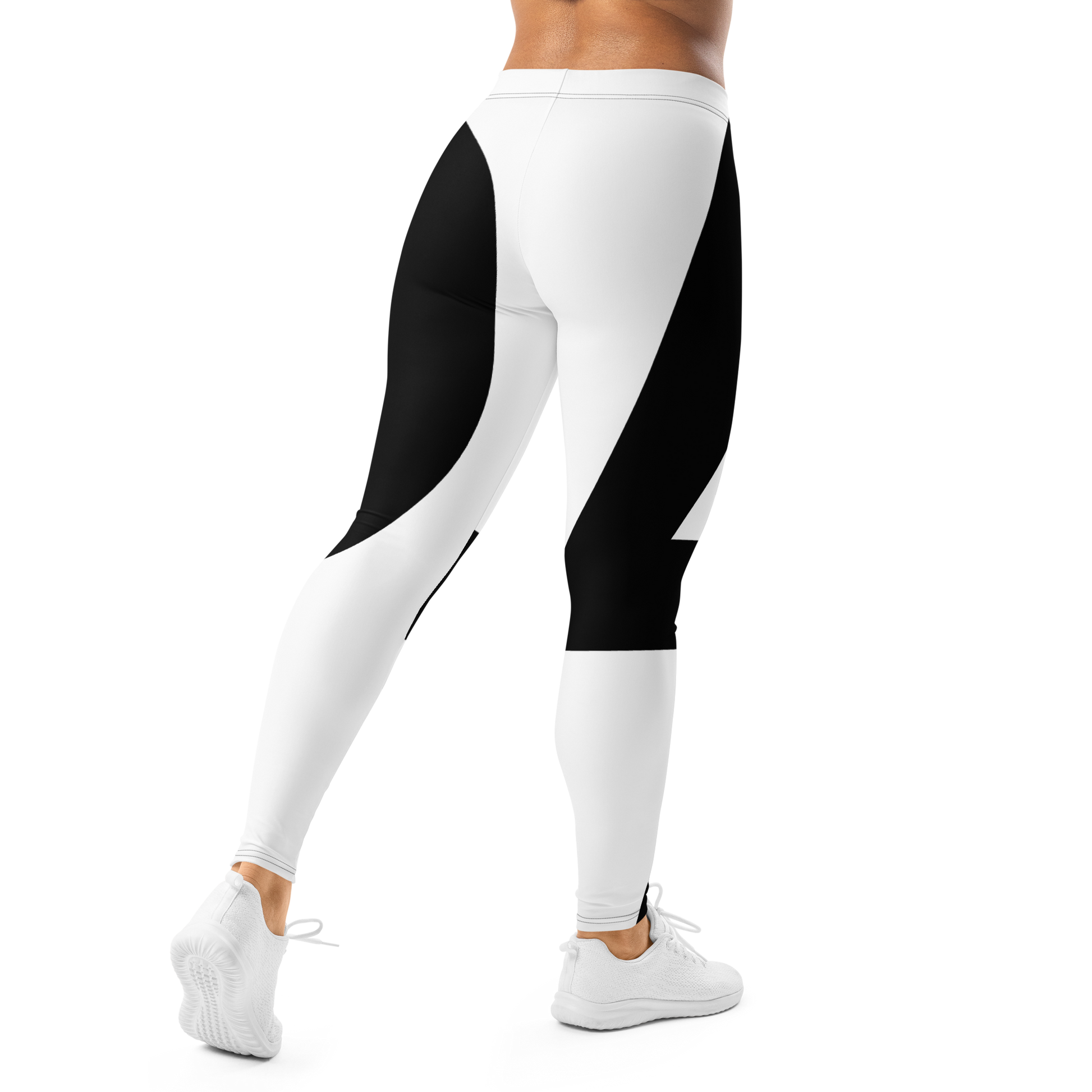Bold black and white LP logo leggings with sweeping curved print, shown from the back right on a standing model, apparel.