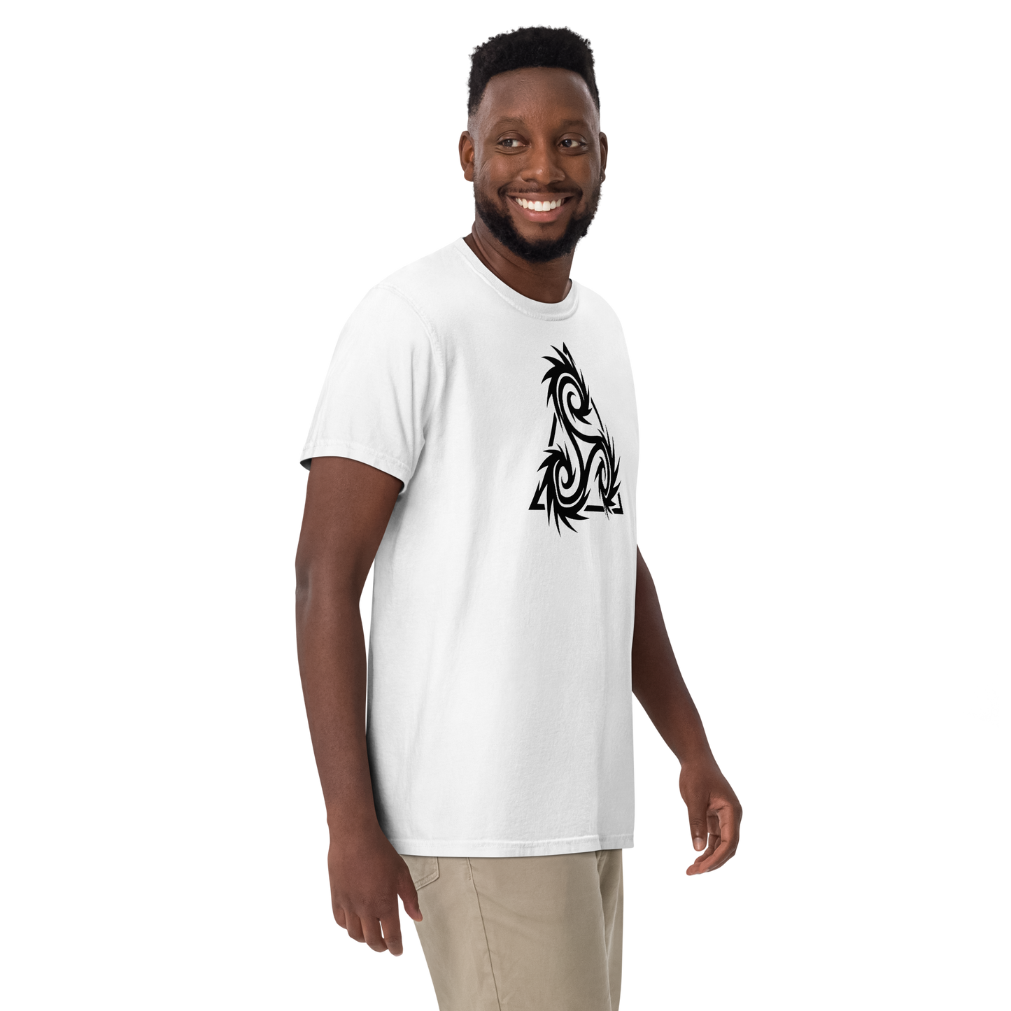 Smiling man wearing a white t-shirt featuring a bold black tribal triskelion design with sharp spikes and swirling spirals on the chest — apparel.