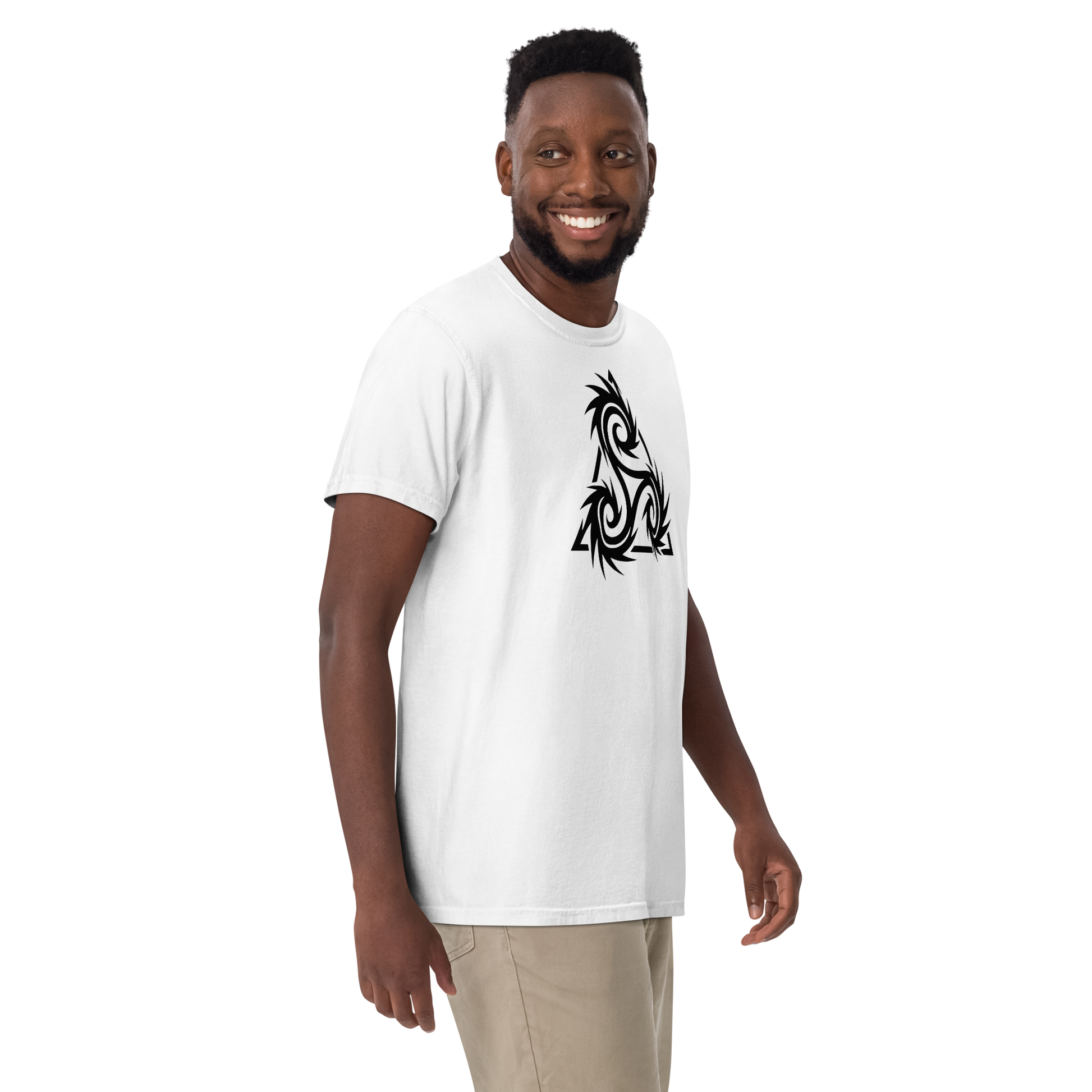 Smiling man wearing a white t-shirt featuring a bold black tribal triskelion design with sharp spikes and swirling spirals on the chest — apparel.