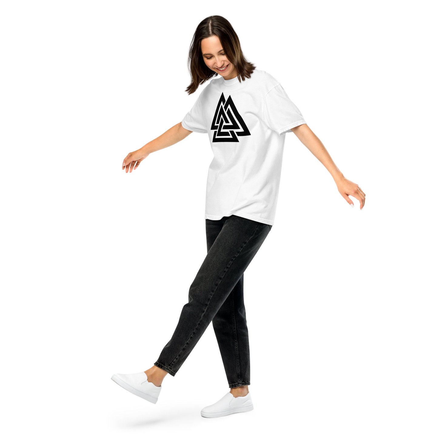 Woman wearing a white oversized t-shirt printed with a bold black Valknut symbol, paired with dark jeans; Norse apparel.