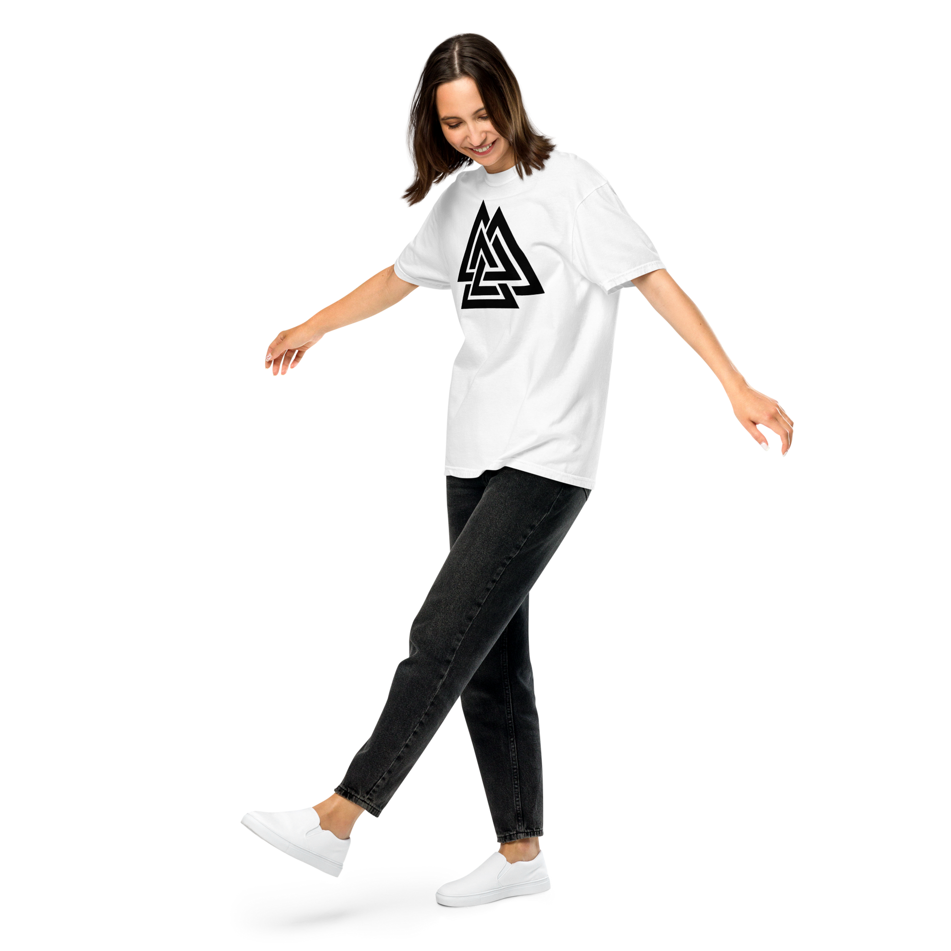 Woman wearing a white oversized t-shirt printed with a bold black Valknut symbol, paired with dark jeans; Norse apparel.