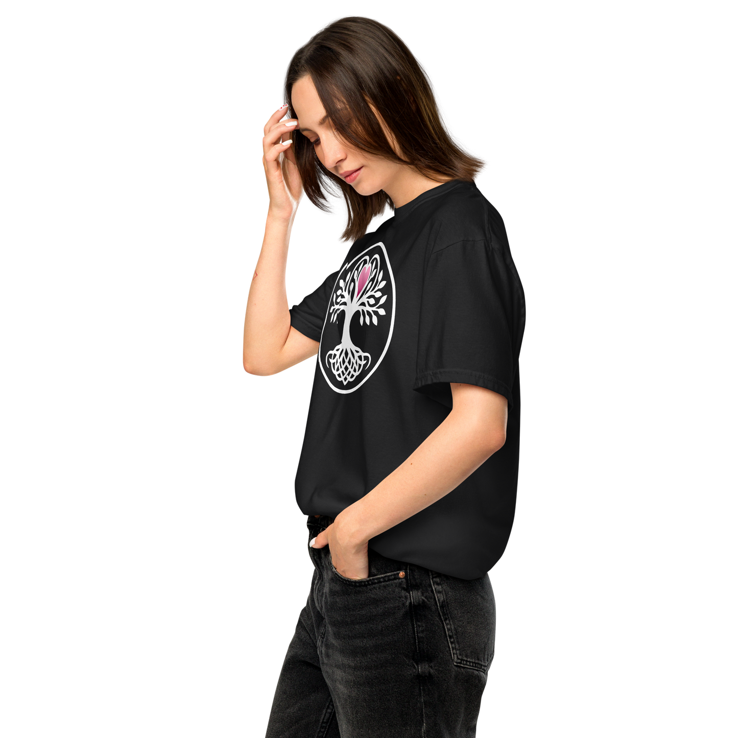 Woman wearing a black t-shirt featuring a white Celtic Yggdrasil tree of life with intertwined roots and a pink heart, set within a white circular border, apparel.