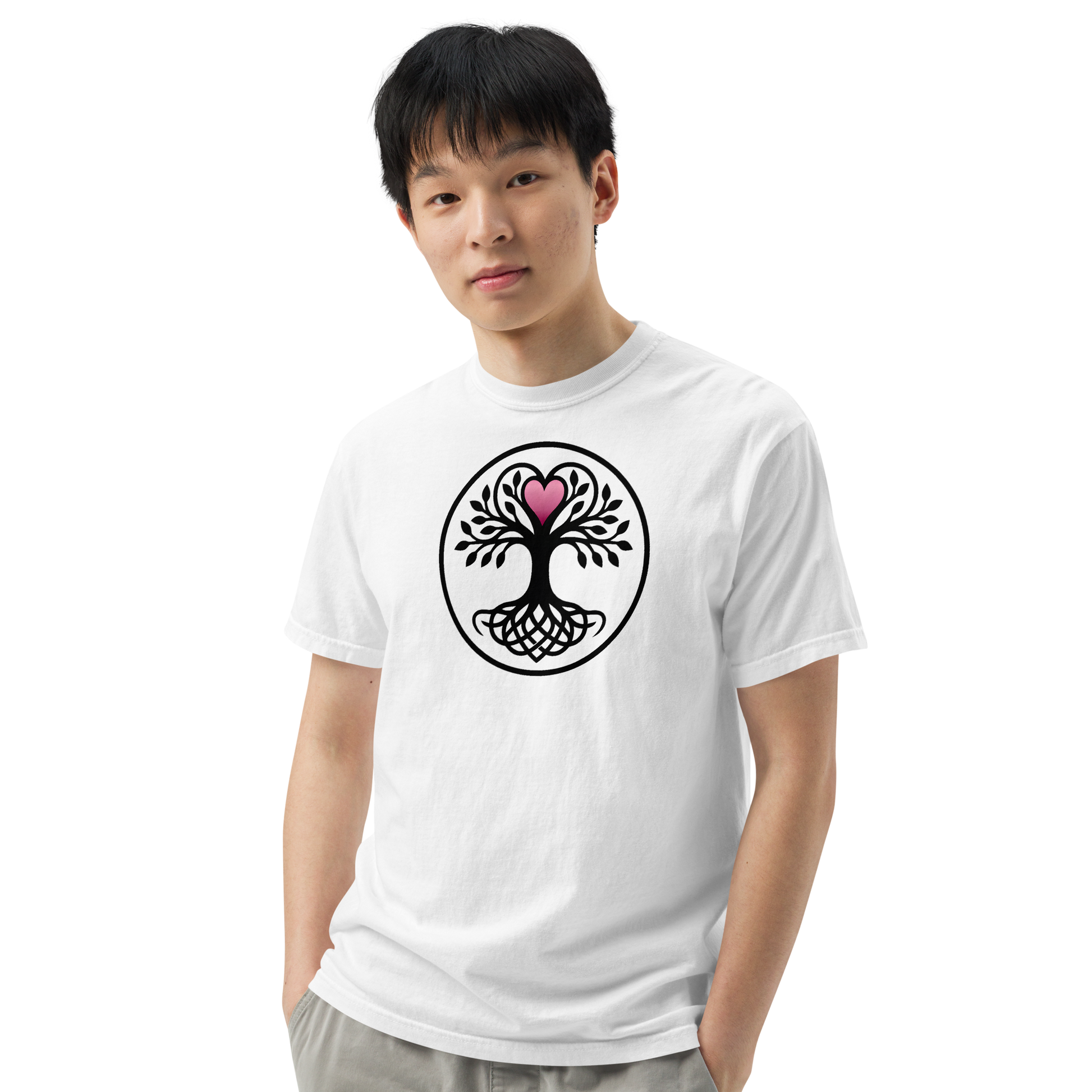 White unisex t-shirt featuring a circular black Celtic Tree of Life graphic with interwoven roots and a pink heart at the crown, worn by a male model.